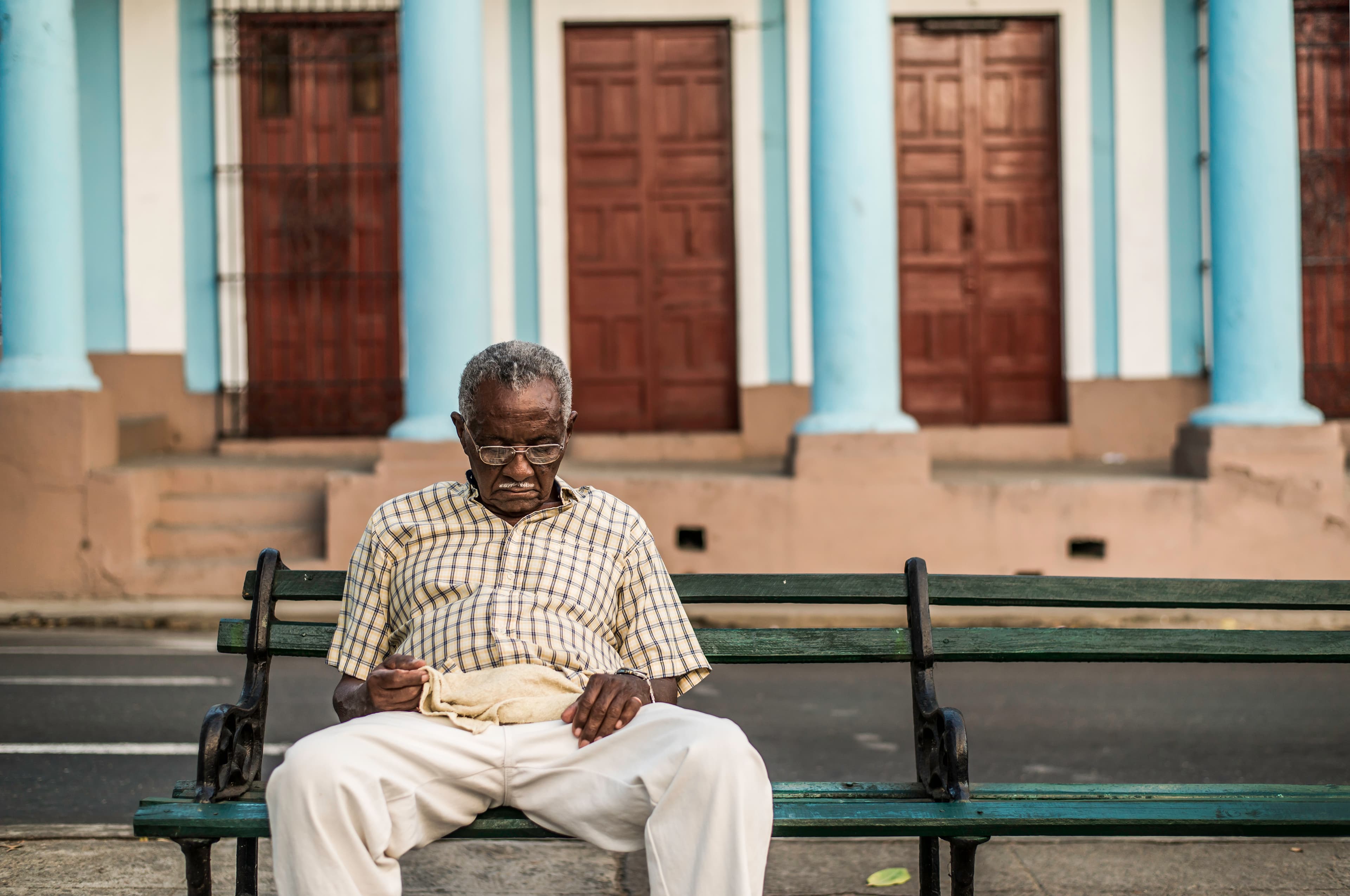 Man seated on bench, Cienfuegos streets
