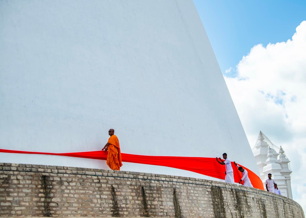 Monks wrap fabric around stupa, Anuradhapura