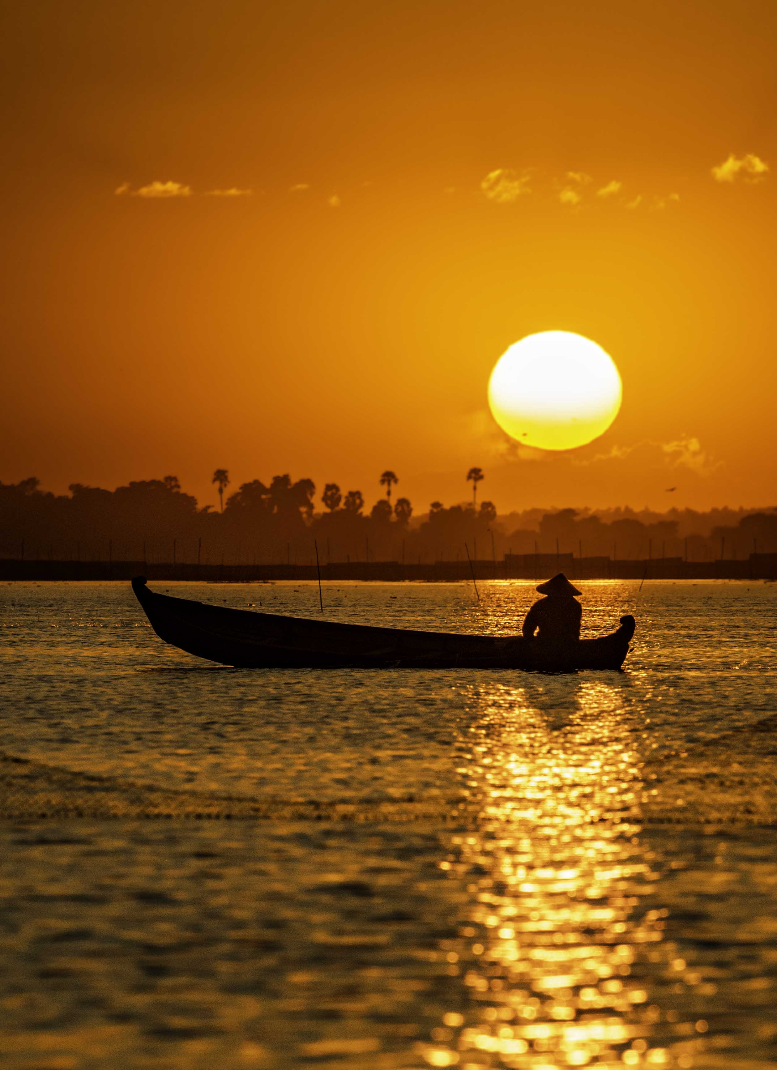 Sunset silhouette on tranquil river, Mandalay