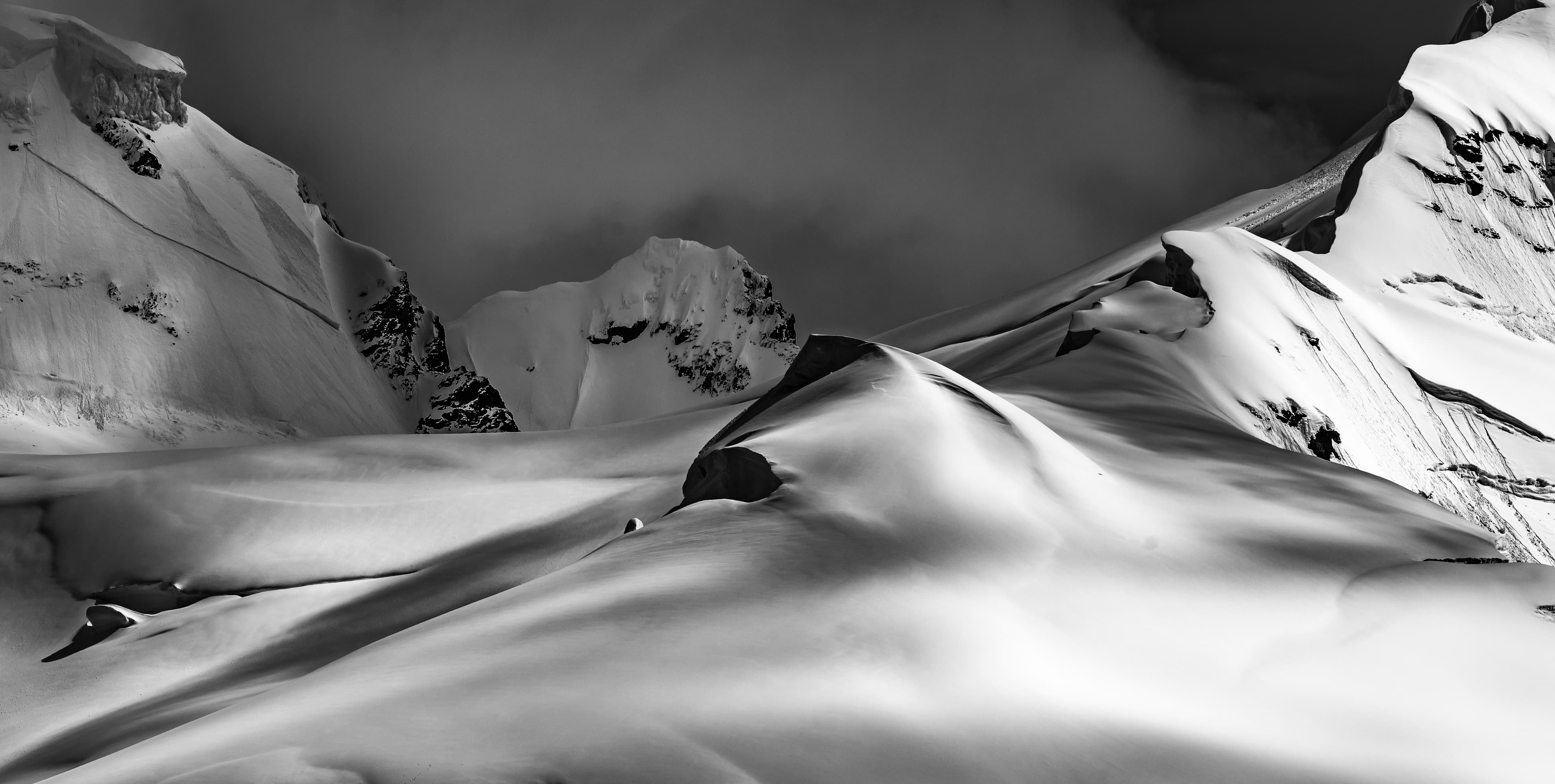 Snow-covered peaks under dramatic sky, Antarctica