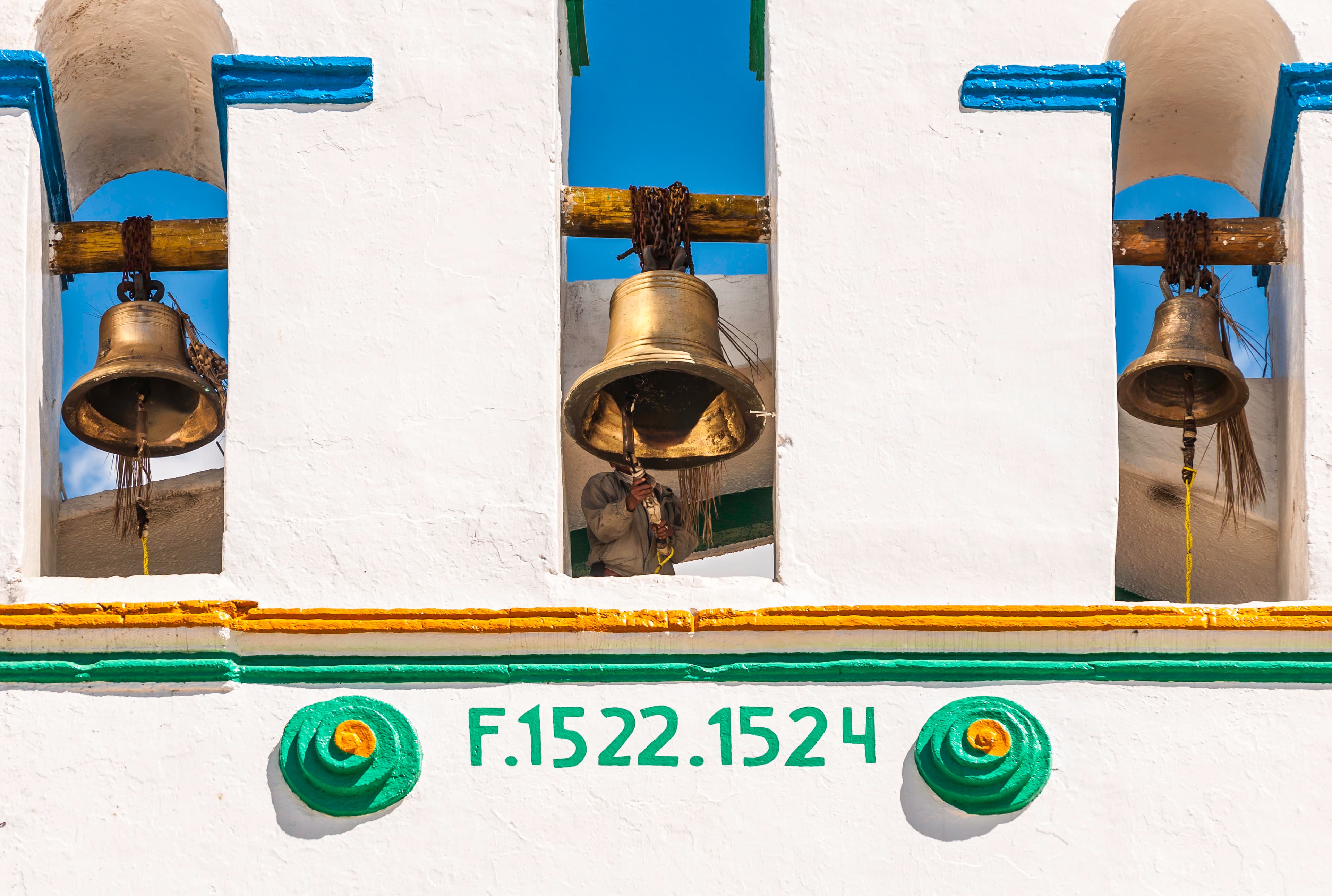 Historic bells against blue sky, San Cristobal